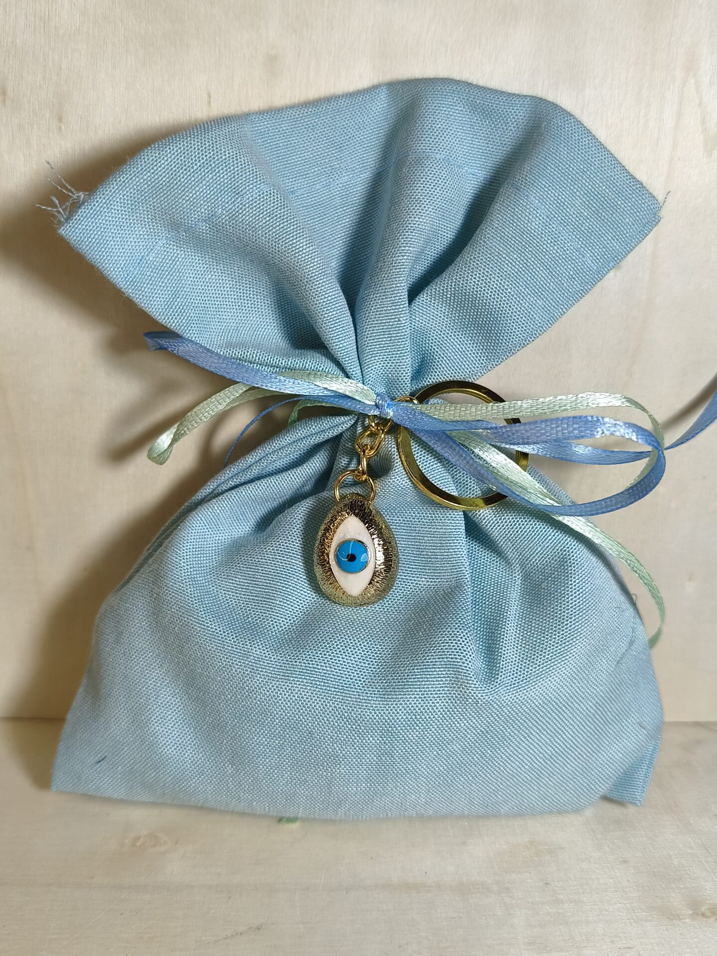 Mπομπονιερα Βαπτισης Πουγκι Βαμβακερο+Ματακι Μπρελοκ